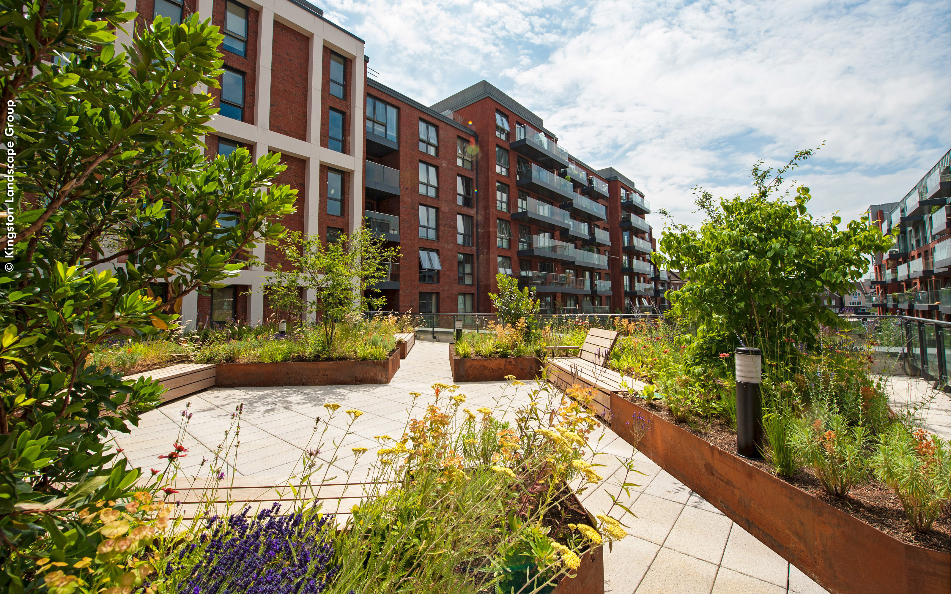 Courtyard with sitting area, surrounded by planters